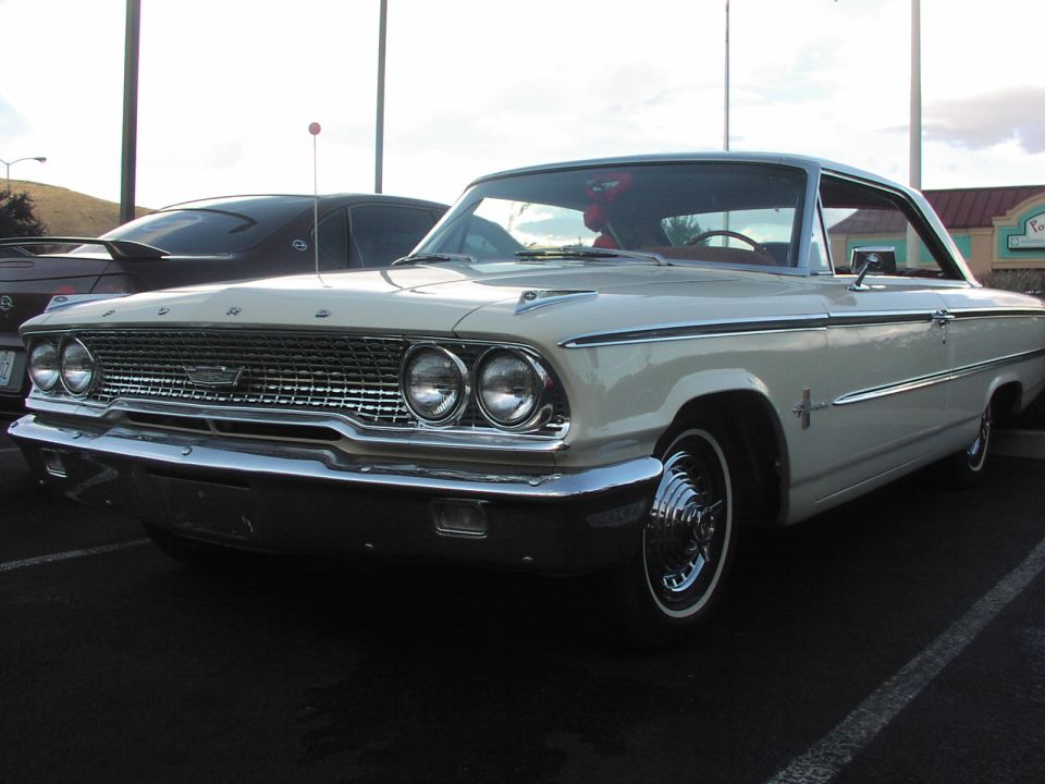 Cream-colored 1963 Ford Galaxie parked in a lot, with a dark car behind it