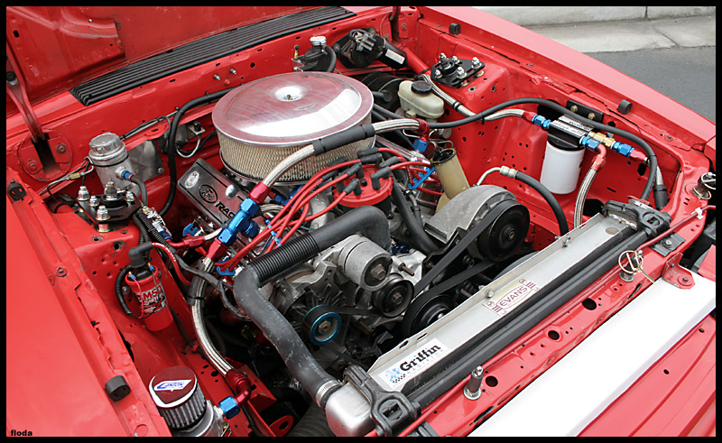 Red 1993 Ford Mustang engine bay with aftermarket parts