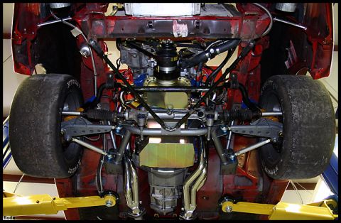 1993 Ford Mustang - The underside of a vehicle is shown, highlighting its suspension and drivetrain components.