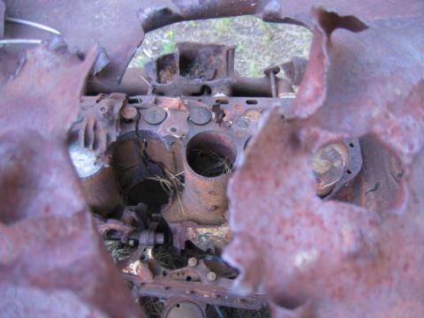 1997 Jeep TJ - This heavily rusted engine block shows significant deterioration, with debris visible inside the cylinders.