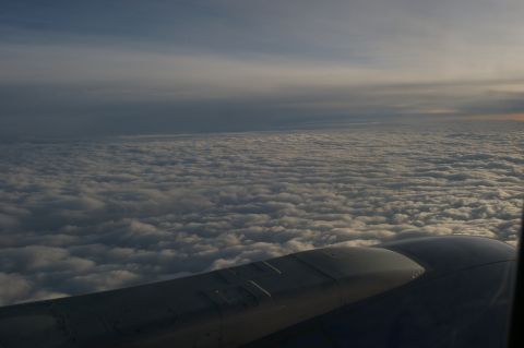1998 Jeep TJ - Airplane wing visible above a sea of clouds during flight.