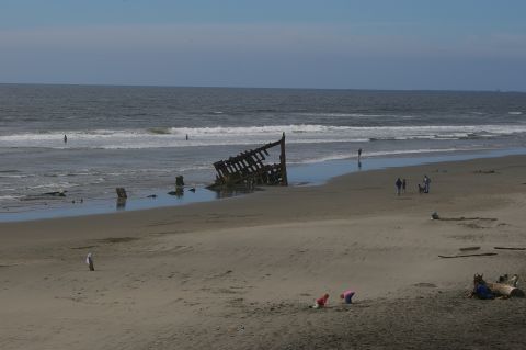 1998 Jeep TJ - Remains of a shipwreck visible on the shore with the ocean waves in the background.