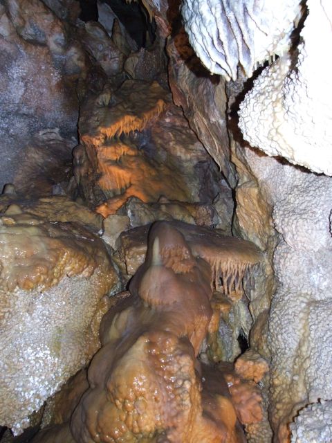 1997 Jeep TJ - Interior of a cave system numerous stalactites and stalagmites, with water evident on rock formations.