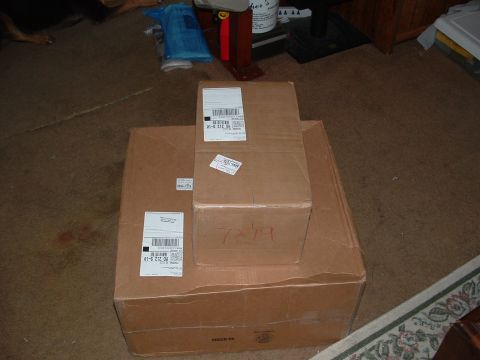 1995 Ford Probe - Cardboard boxes are stacked on a carpeted floor, with shipping labels visible on the sides.