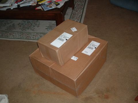 1995 Ford Probe - Two cardboard boxes are stacked on a carpeted floor, with a coffee table visible in the background.