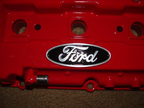 1995 Ford Probe - A red Ford valve cover is shown up close, displaying the Ford emblem.
