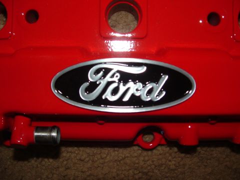 1995 Ford Probe - Red Ford valve cover with a black oval emblem the Ford logo. Part of the SuperMotors.net website is visible at the bottom.