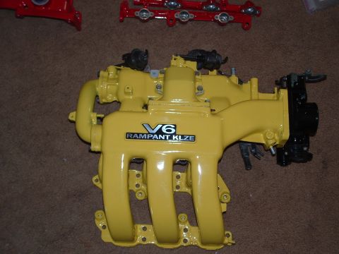 1995 Ford Probe - A yellow V6 intake manifold with "RAMPANT KLZE" text is shown against a brown background.