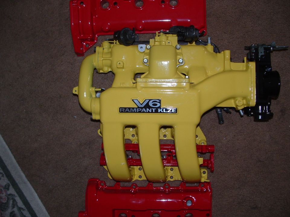 Yellow V6 intake manifold with red engine block parts
