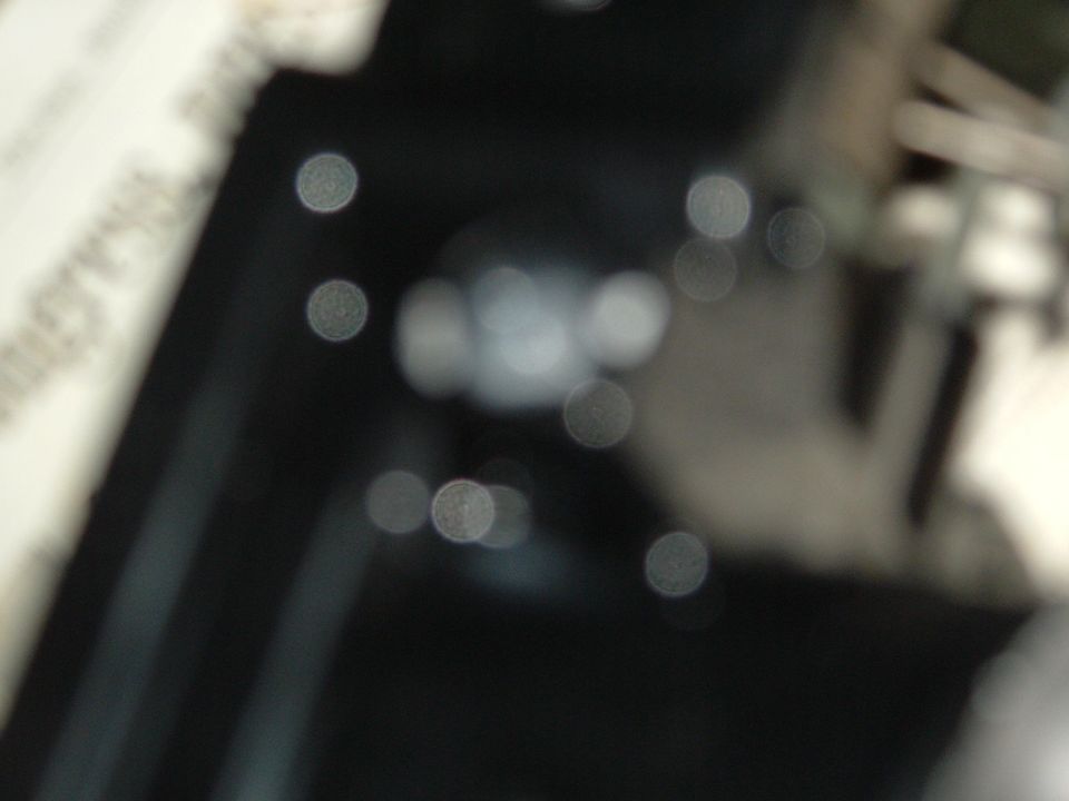 Out-of-focus interior shot showing bokeh lights and dark surfaces