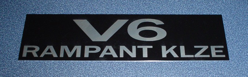 Black rectangular badge with silver text 'V6 RAMPANT KLZE'