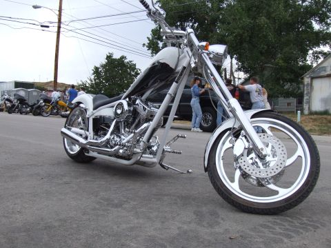 1997 Jeep TJ - A custom motorcycle is parked on the street with other motorcycles in the background.