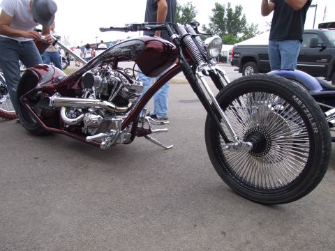 1997 Jeep TJ - A custom chopper motorcycle with a striking maroon frame and intricate chrome engine details is displayed outdoors.