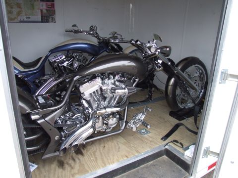 1997 Jeep TJ - Two custom motorcycles are secured inside a trailer, ready for transport.