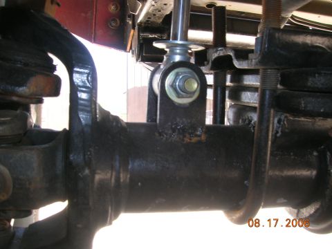 1985 Ford Bronco - The image shows a close-up of a vehicle's suspension system, focusing on the axle and shock absorber mount.