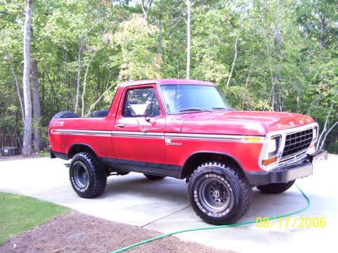 1979 Ford Bronco - This red 1979 Ford Bronco is shown from a three-quarter front view, a spare tire mounted on the back.