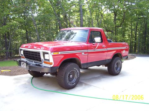 1979 Ford Bronco - A red 1978 Ford Bronco is shown from a three-quarter front angle, parked outdoors.