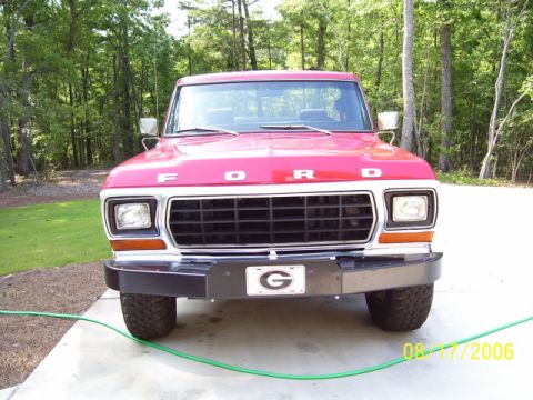 1979 Ford Bronco - This red Ford truck, likely from the late 1970s, is shown from a straight-on front view.