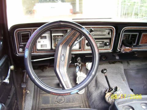 1979 Ford Bronco - The interior of an older truck shows the dashboard, steering wheel, and floor-mounted shifter.