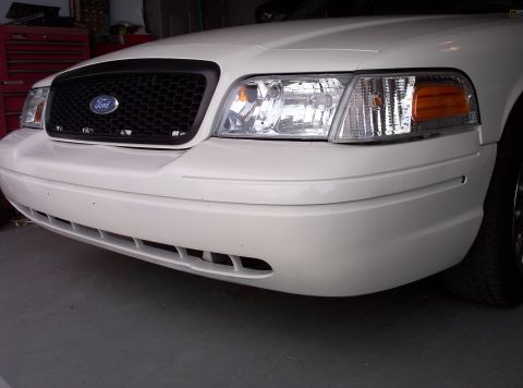 1998 Ford Crown Victoria - Front view of a white Ford Crown Victoria, showing its grille and headlights.