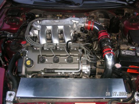 1993 Ford Probe - Close-up view of a Ford V6 engine, showing intake piping and other engine components.