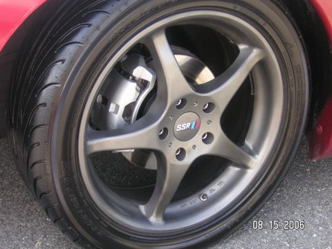 1993 Ford Probe - Close-up of a car's wheel and tire assembly, showing aftermarket modifications.