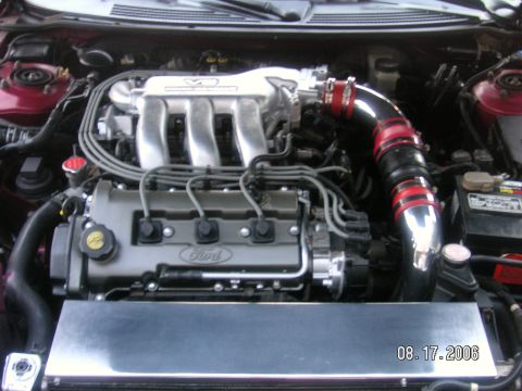 1993 Ford Probe - Engine bay view of a Ford V6 with custom intake components and visible "Ford" branding on the valve cover.