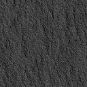 1995 Ford Bronco - A close-up view of a dark, textured surface, possibly asphalt or a similar material.