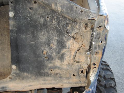 1977 Ford F-150 - This photo shows the inner fender well of a truck, revealing rust and exposed wiring.