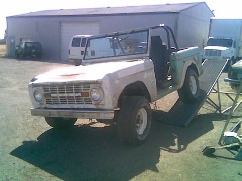 1991 Ford Explorer - A vintage Ford Bronco is positioned on a metal ramp, with its doors detached, ready for work.