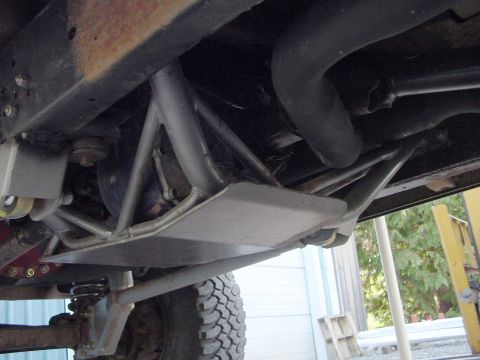 1979 Ford Bronco - The photo shows the undercarriage of a vehicle, focusing on a skid plate and suspension system, not the entire vehicle.
