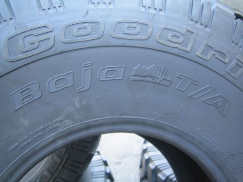1990 Ford Bronco - Detailed close-up of a BFGoodrich Baja T/A tire sidewall showing the embossed brand and model lettering.