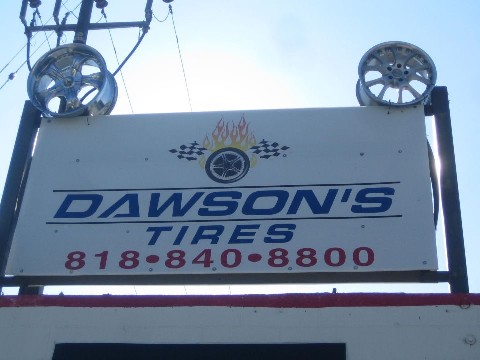 Dawson's Tires shop sign with chrome wheels and phone number 818-840-8800
