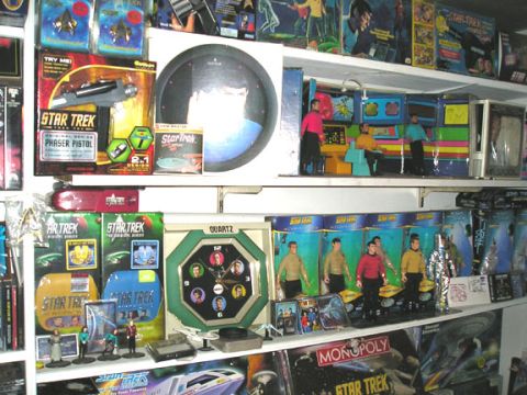 1984 Pontiac Fiero - A collection of Star Trek toys and merchandise displayed on shelves, action figures and various collectibles.