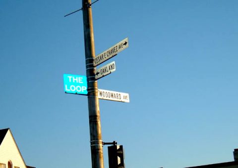 1971 Ford Ranchero - A collection of street signs points in various directions under a bright blue sky.