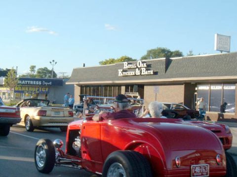 1971 Ford Ranchero - Several cars are seen on a street in front of businesses, including a red hot rod and a gold convertible.