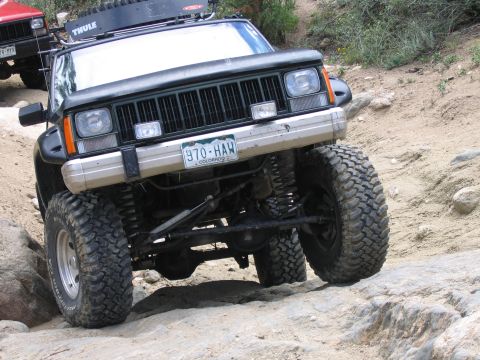 1996 Jeep Cherokee - Jeep Cherokee navigating a challenging off-road course with another vehicle following.