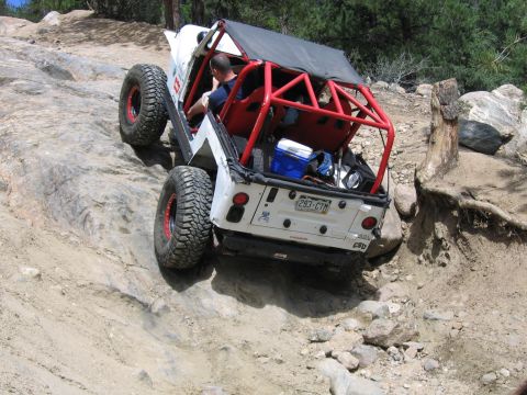 1996 Jeep Cherokee - This modified Jeep Wrangler navigates a steep, rocky incline on an off-road trail.