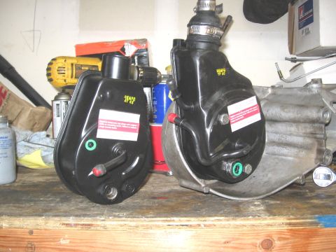 1994 Ford Bronco - Two power brake boosters are shown on a wooden workbench, with tools and other automotive parts in the background.