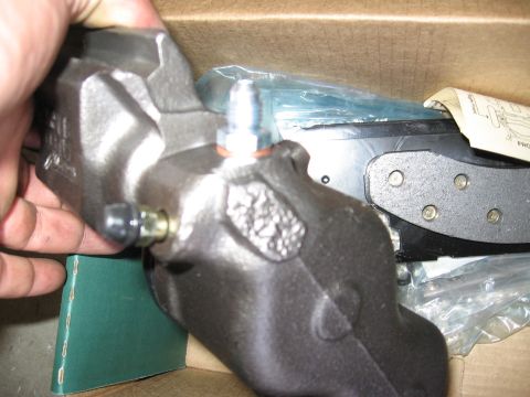 1994 Ford Bronco - A brake caliper and pads are shown, with a diagram visible in the background.