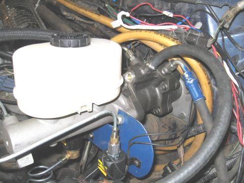 1994 Ford Bronco - Close-up of brake master cylinder reservoir and hydroboost unit, showing hoses and wiring.
