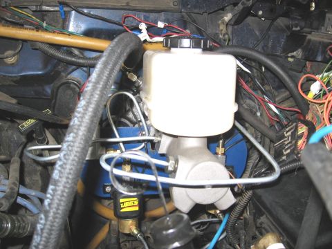 1994 Ford Bronco - The photo shows a close-up view of the brake master cylinder and hydroboost unit, with various hoses and electrical wiring visible.