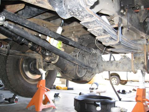1994 Ford Bronco - The underside of a vehicle is shown, focusing on the rear axle and suspension components.