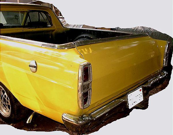 Yellow Ford Ranchero pickup, rear three-quarter view with taillight and bumper