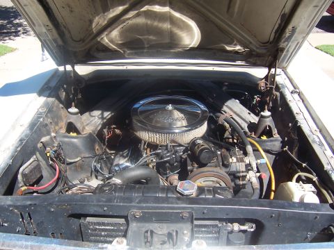 1964 Ford Ranchero - Engine bay of a 1964 Ford Ranchero, a chrome air cleaner and visible engine components.