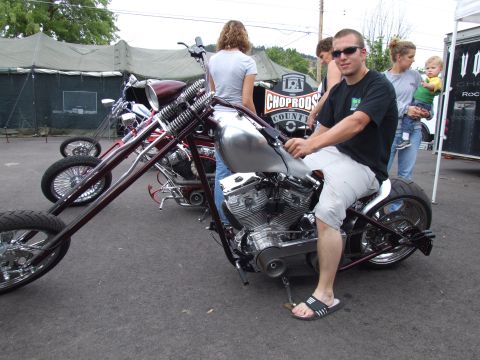 1997 Jeep TJ - A man sits on a custom motorcycle with a large engine and spoked wheels, with other motorcycles and people in the background.