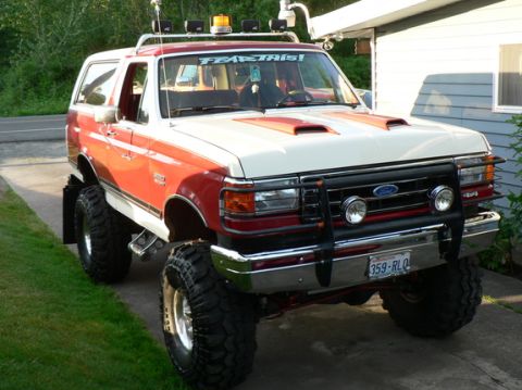 1989 Ford Bronco - This modified Ford Bronco features a prominent grille guard and auxiliary lighting, suggesting a later model year than claimed.