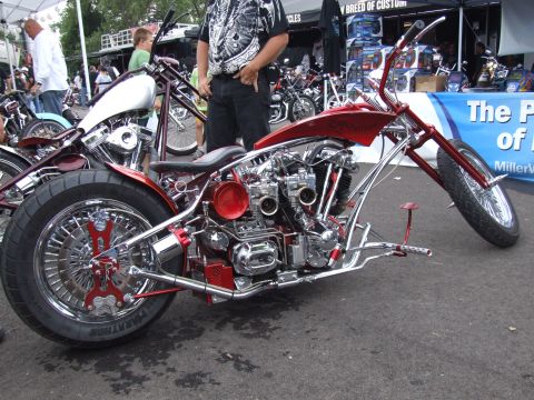 1997 Jeep TJ - Custom chopper motorcycle on display at an outdoor event, with other bikes and people in the background.