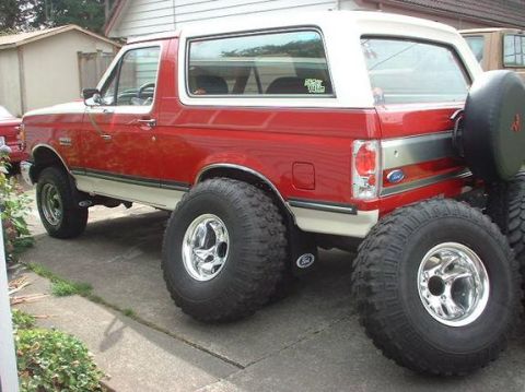 1989 Ford Bronco - with 36's leaning up against the truck