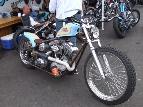 1997 Jeep TJ - A custom motorcycle with a unique paint scheme is parked outdoors, with other vehicles in the background.